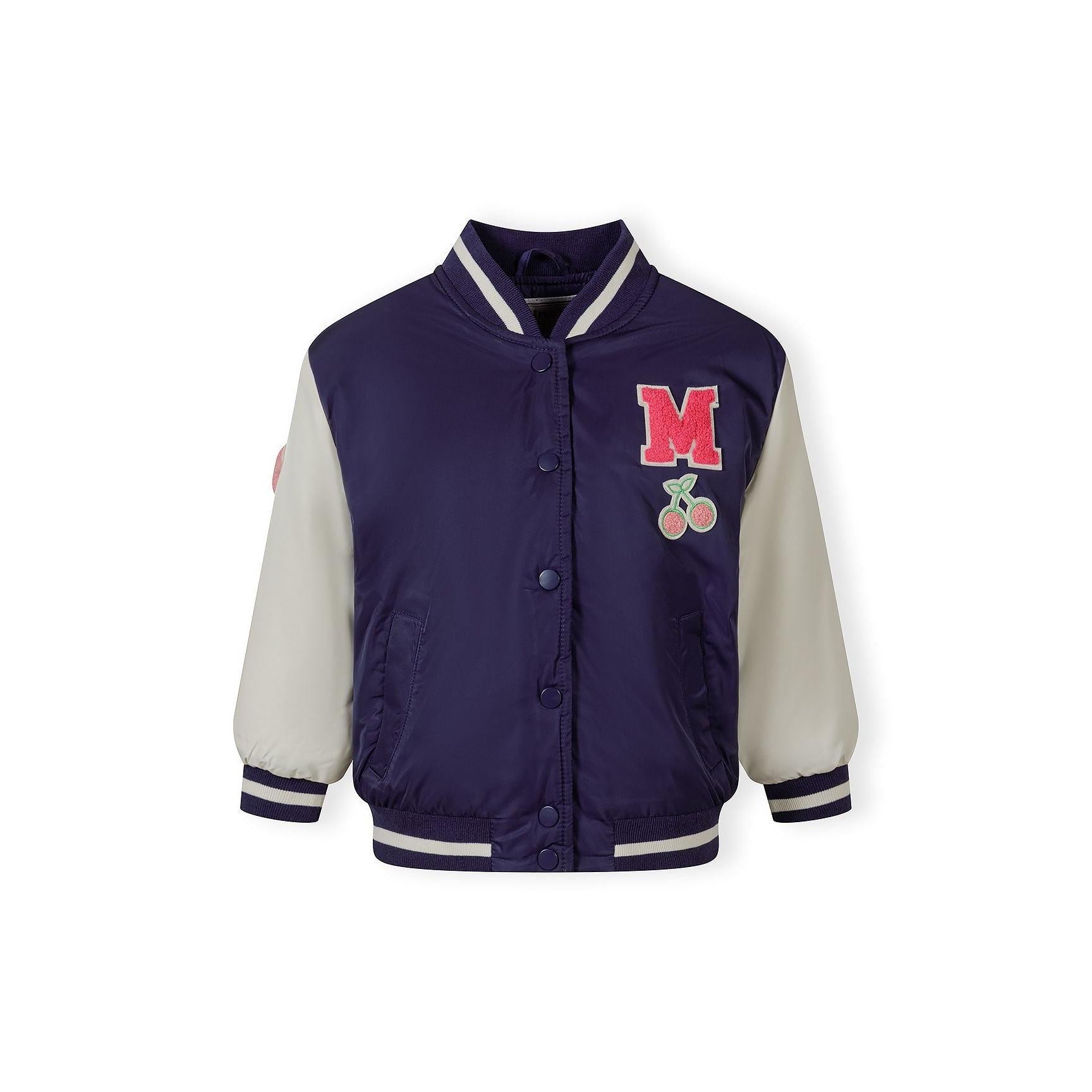 Navy bomber jacket with white sleeves laid flat showing red letter M patch and cherry embroidery details