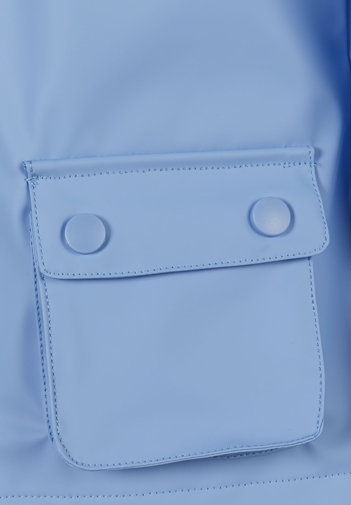 Close-up of the pocket on the blue hooded jacket.