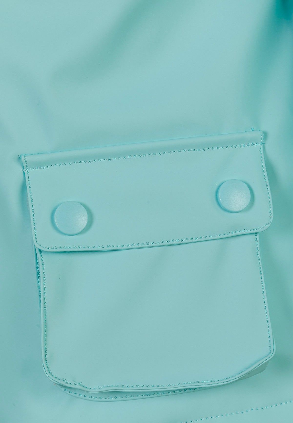 Close-up of the pocket on the mint green hooded jacket.