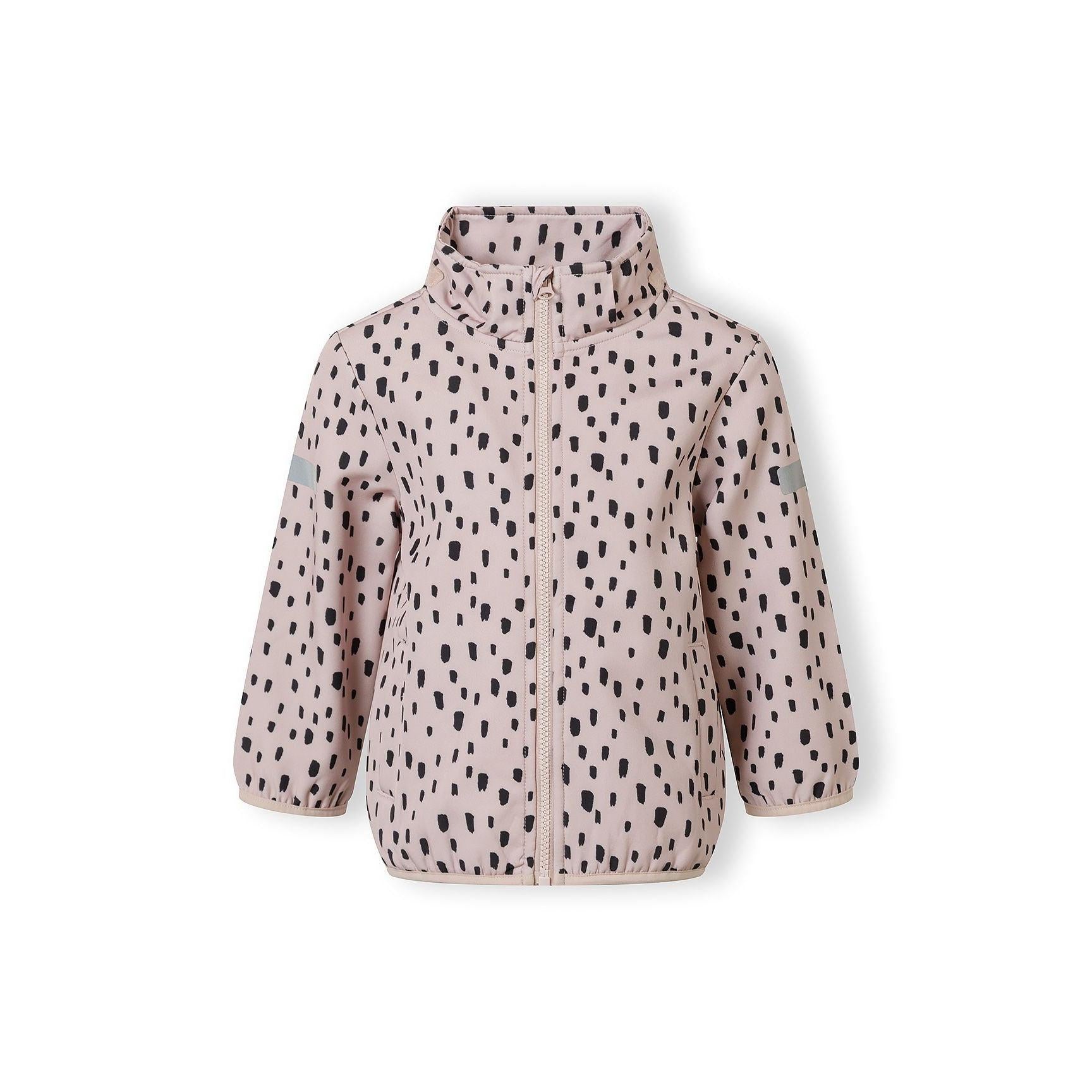 Close-up detail of pink fabric with black spotted pattern showing front pocket with stitched edges and fabric texture