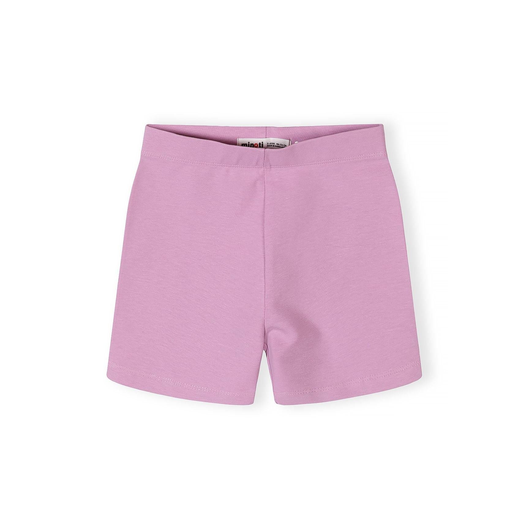 Close-up detail of pink cycle shorts with colorful heart print pattern showing yellow, mint green, and pink hearts on lilac background