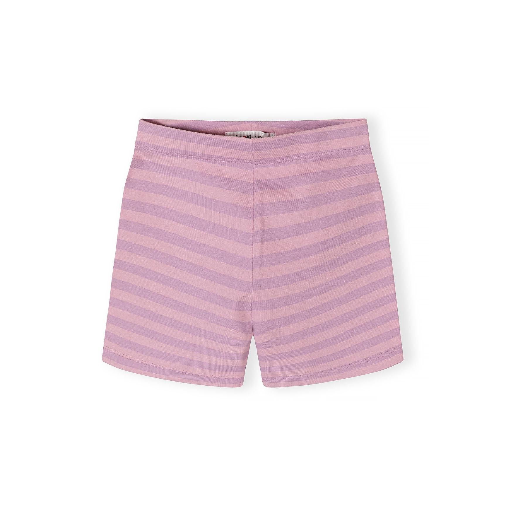 Close-up detail of pink cycle shorts with colorful heart print pattern showing yellow, mint green, and pink hearts on lilac background
