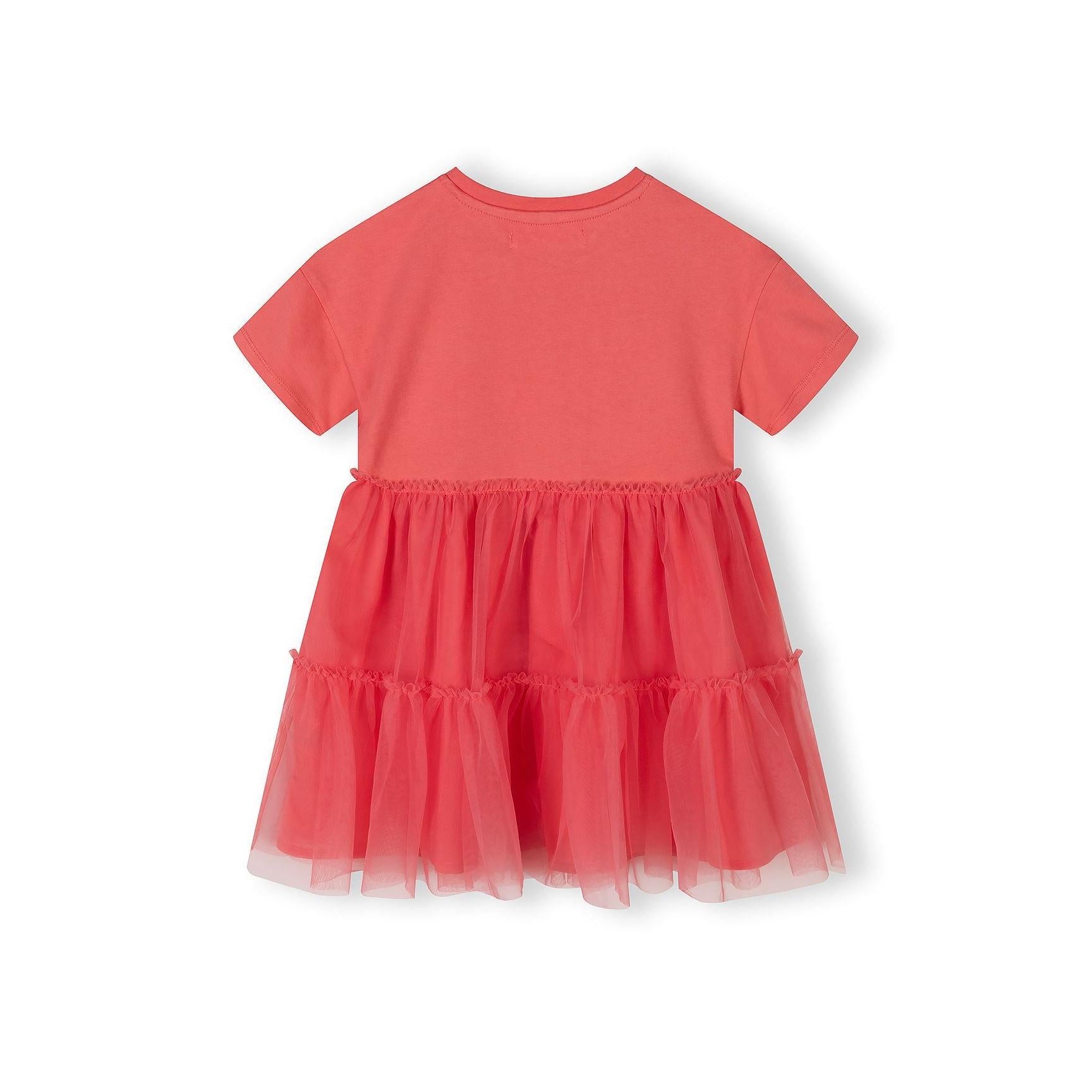 Back view of coral tulle dress showing tiered tulle skirt layers and cotton jersey bodice construction on white background