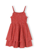 Girls red floral sleeveless summer dress with adjustable straps, front view.
