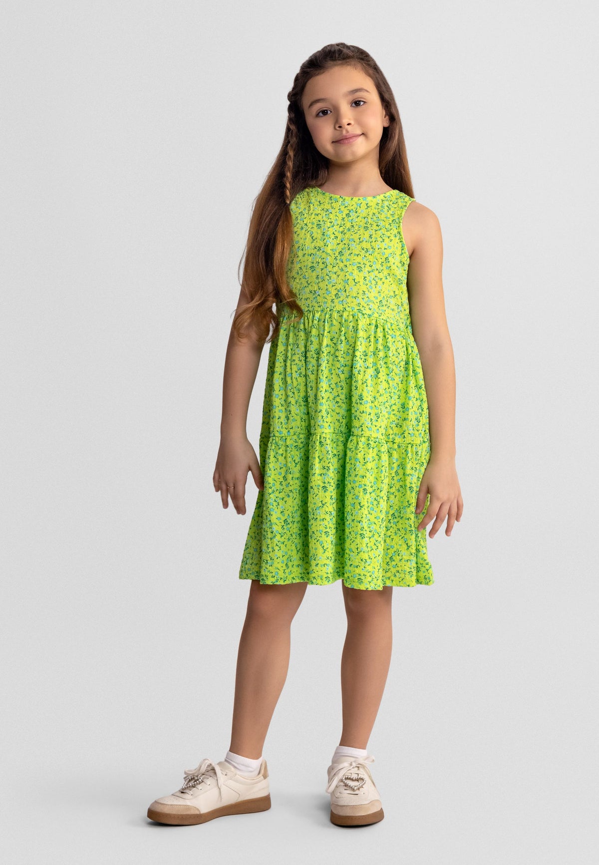 Lime green and blue floral bow-back sundress, model front.