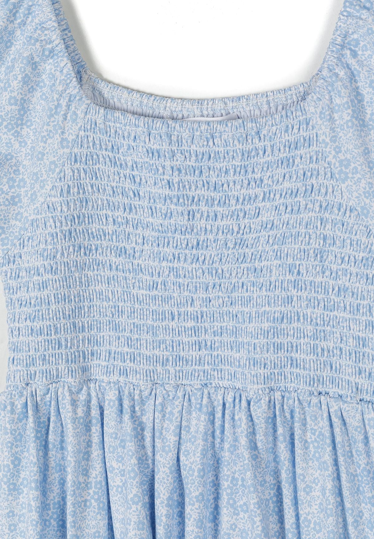 Light blue and white shirred floral dress, shirring detail.