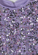 Detail of a girls' a-line dress with multicolour sequins on a lilac background.