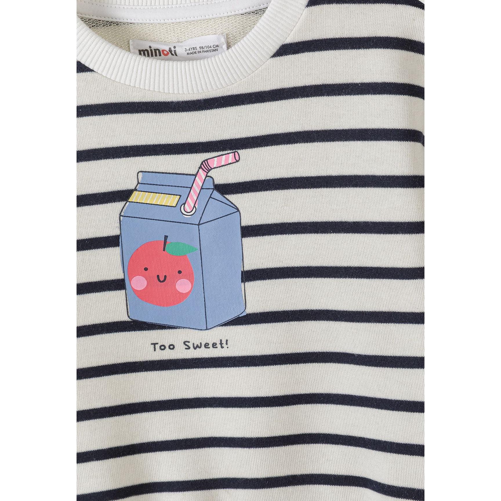 Detail shot of apricot sweatshirt showing cute kawaii-style apple print with smiling faces, green leaves and ribbed neckline