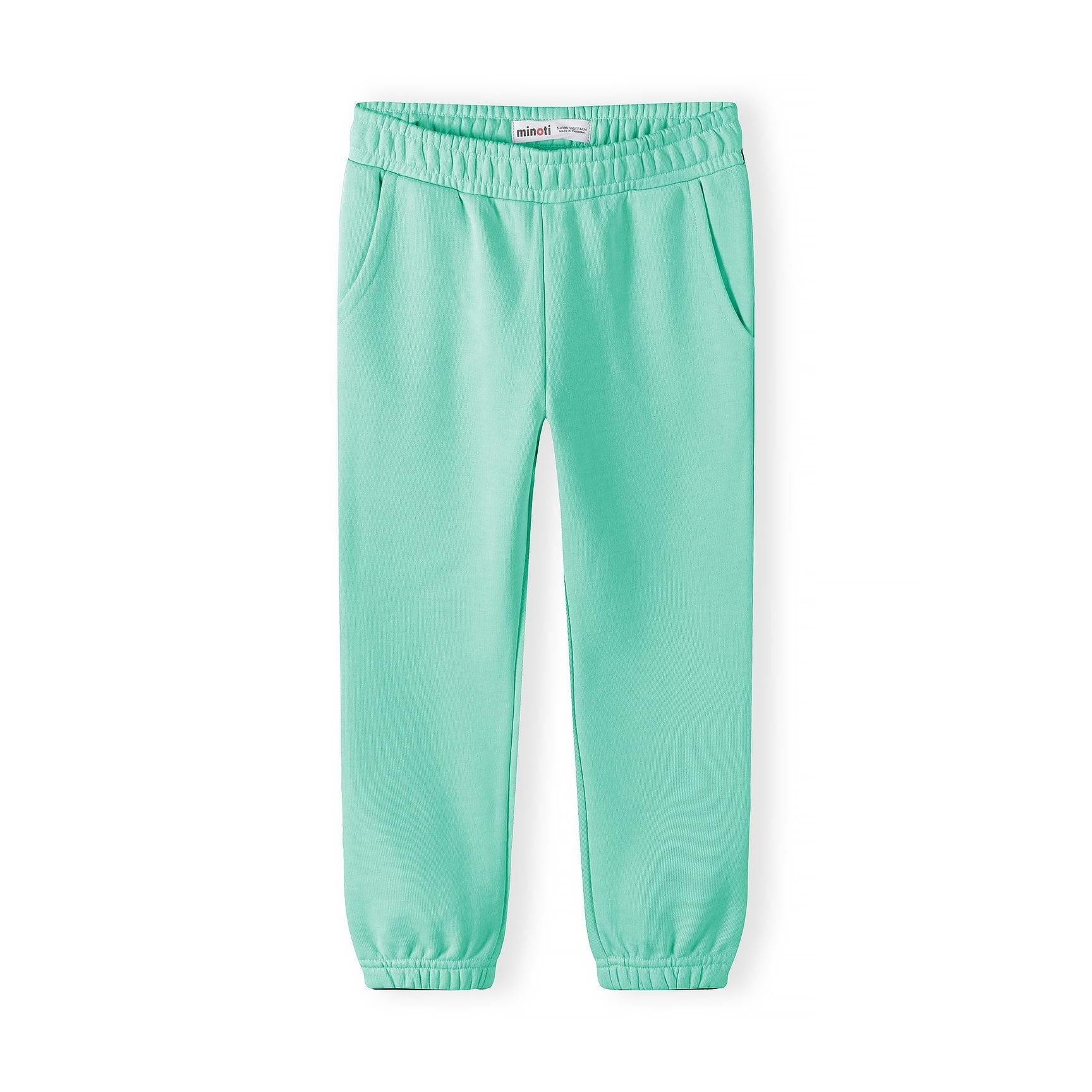 Single coral pink jogger laid flat showing elasticated waistband, side pockets and cuffed ankles on white background