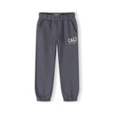 Close-up of blue-grey tracksuit bottoms showing elastic waistband and CALI USA Dance Studio text print on the leg