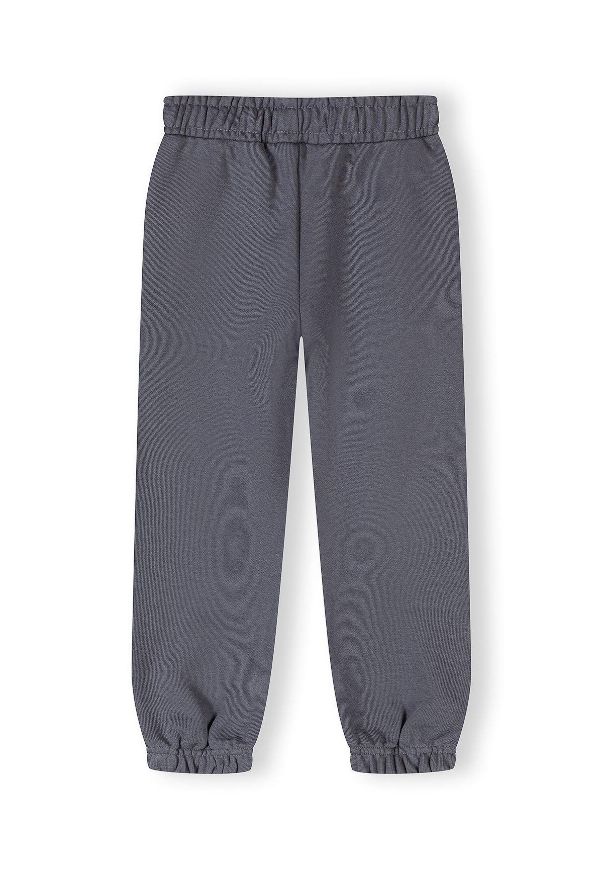 Detail of girls' tapered jogging trousers in blue-grey with elasticated waistband.