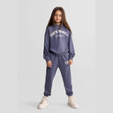 Girls' blue-grey hooded tracksuit with tapered trousers, featuring logo details.