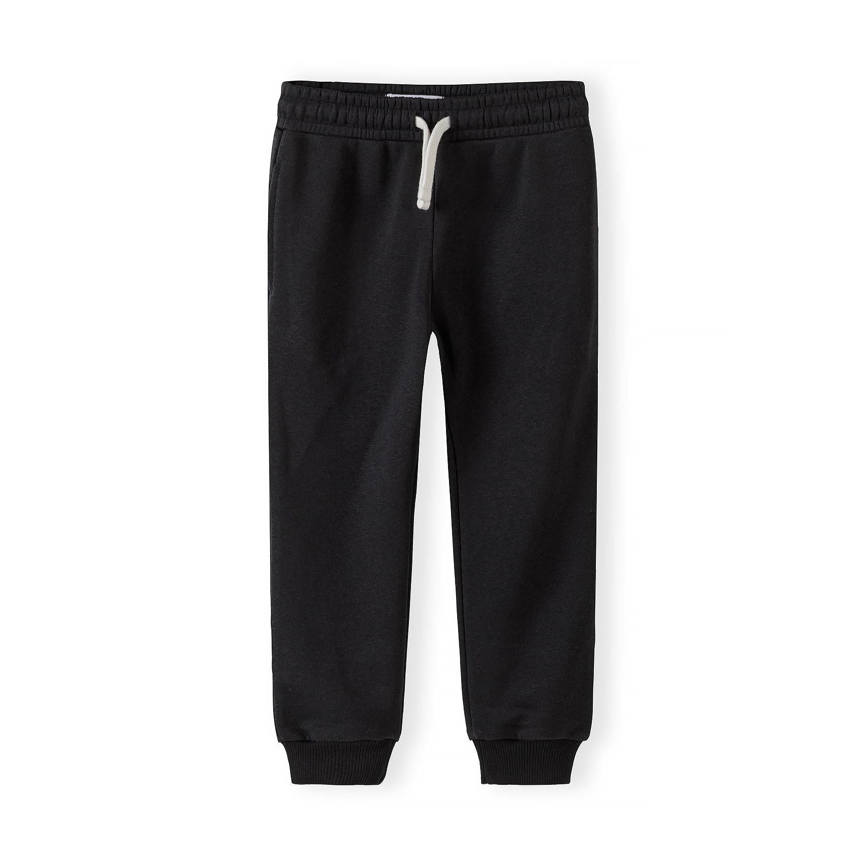 Single light pink joggers laid flat showing full length with white drawstring, elastic waistband and ribbed cuffs on white background
