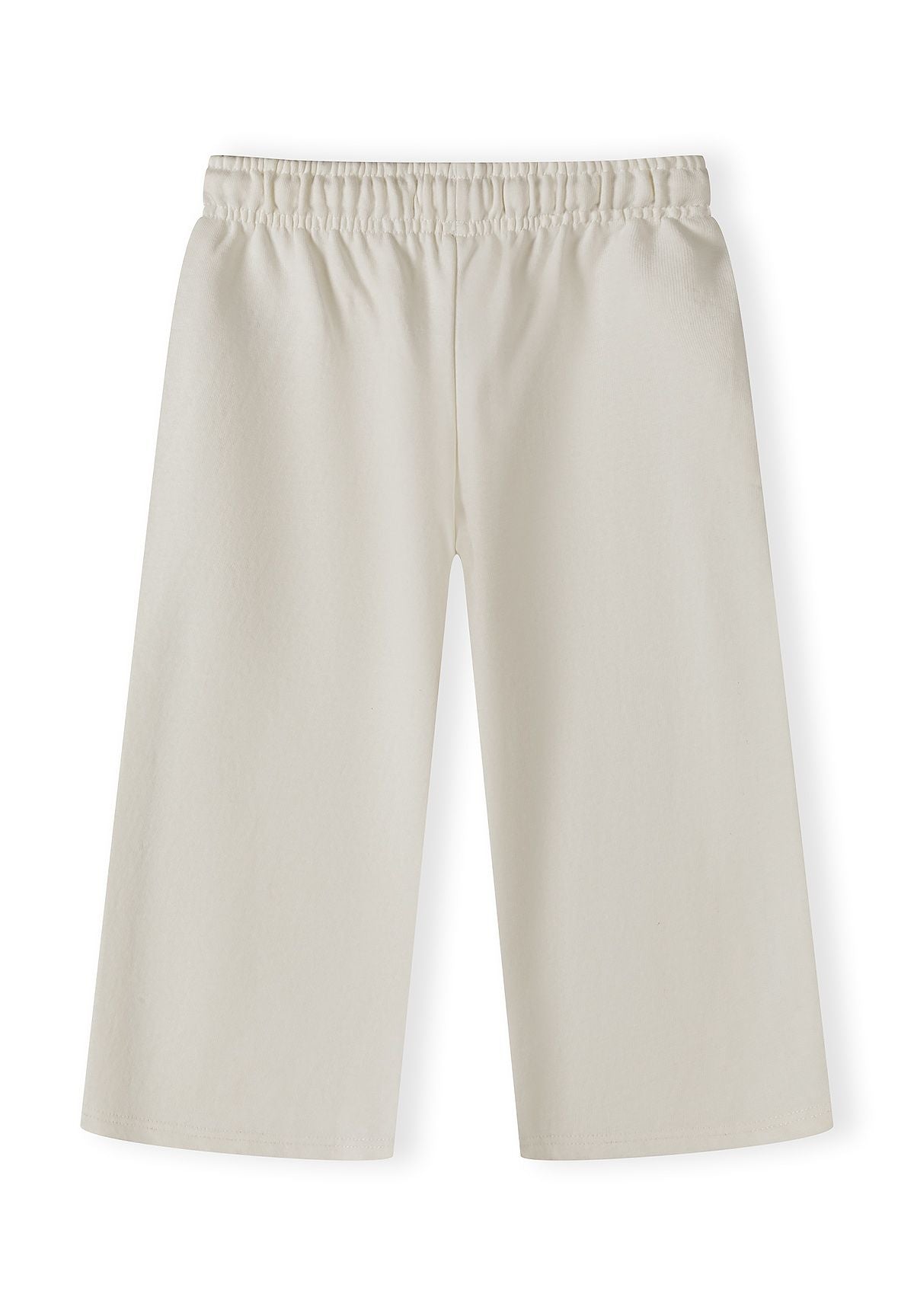 Detail of girls' loose-fitting jogging bottoms with elasticated waistband.