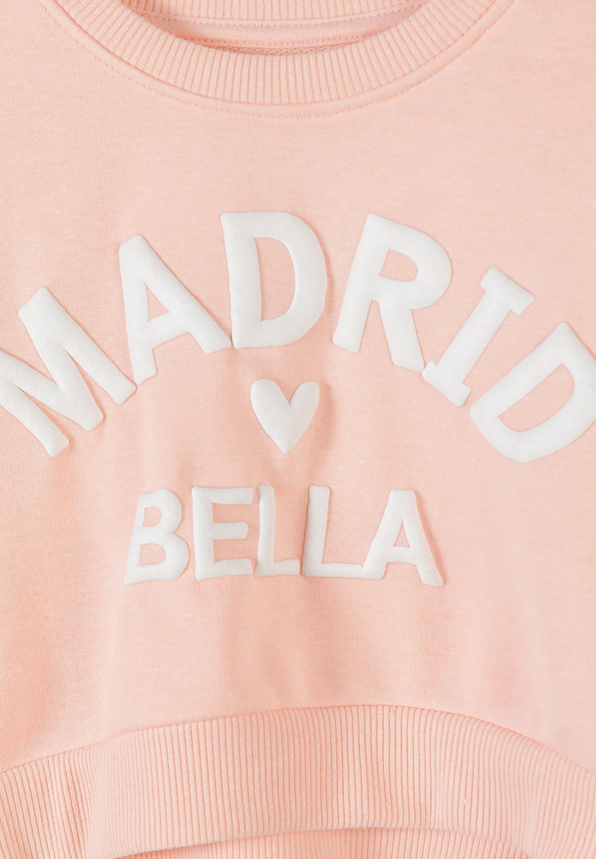 Peach sweatshirt and shorts set, chest lettering detail.