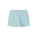 Close-up of mint green shorts showing embroidered palm tree detail and white bow tie at elasticated waistband