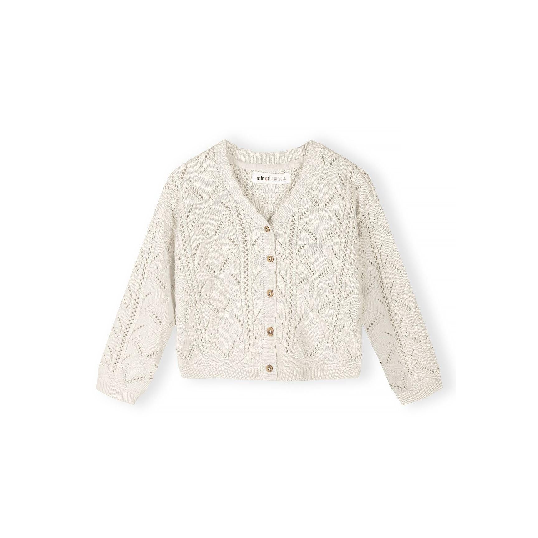 White cotton pointelle cardigan laid flat showing intricate knit pattern, round neckline and wooden button closure with Minoti label visible