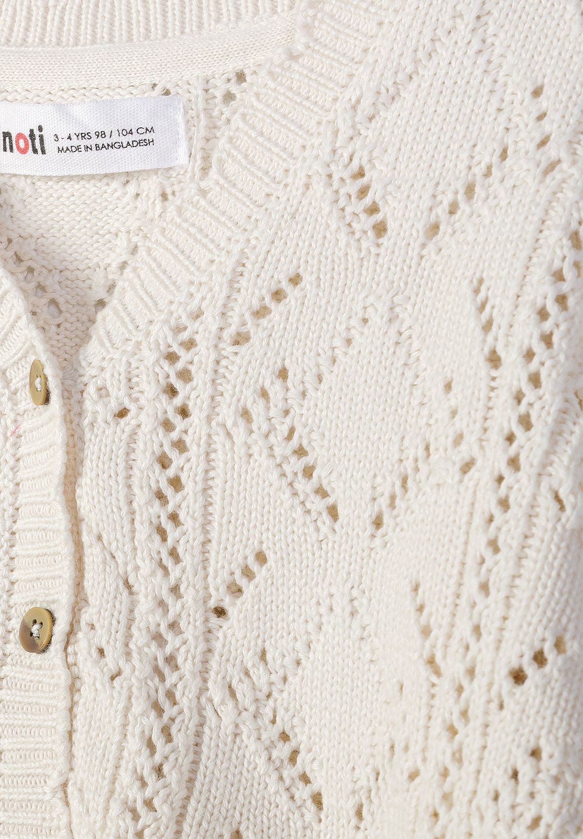 Off-white pointelle cardigan, knit and button detail.