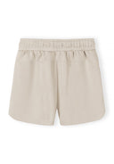 Beige girls shorts with elasticated waist, simple design ideal for casual kids and baby fashion.
