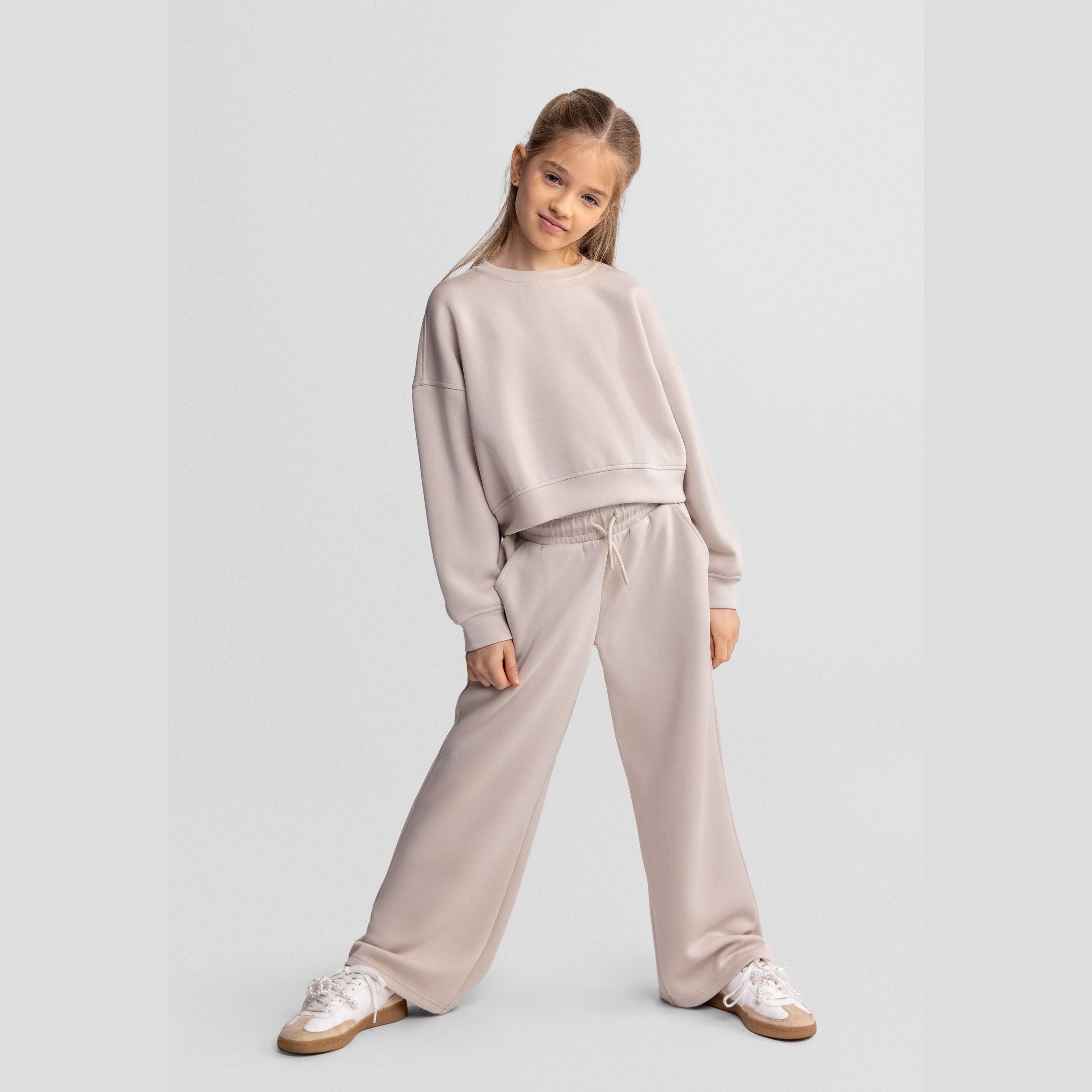 Flat lay view of beige wide leg joggers showing full garment shape and wide leg silhouette on white background