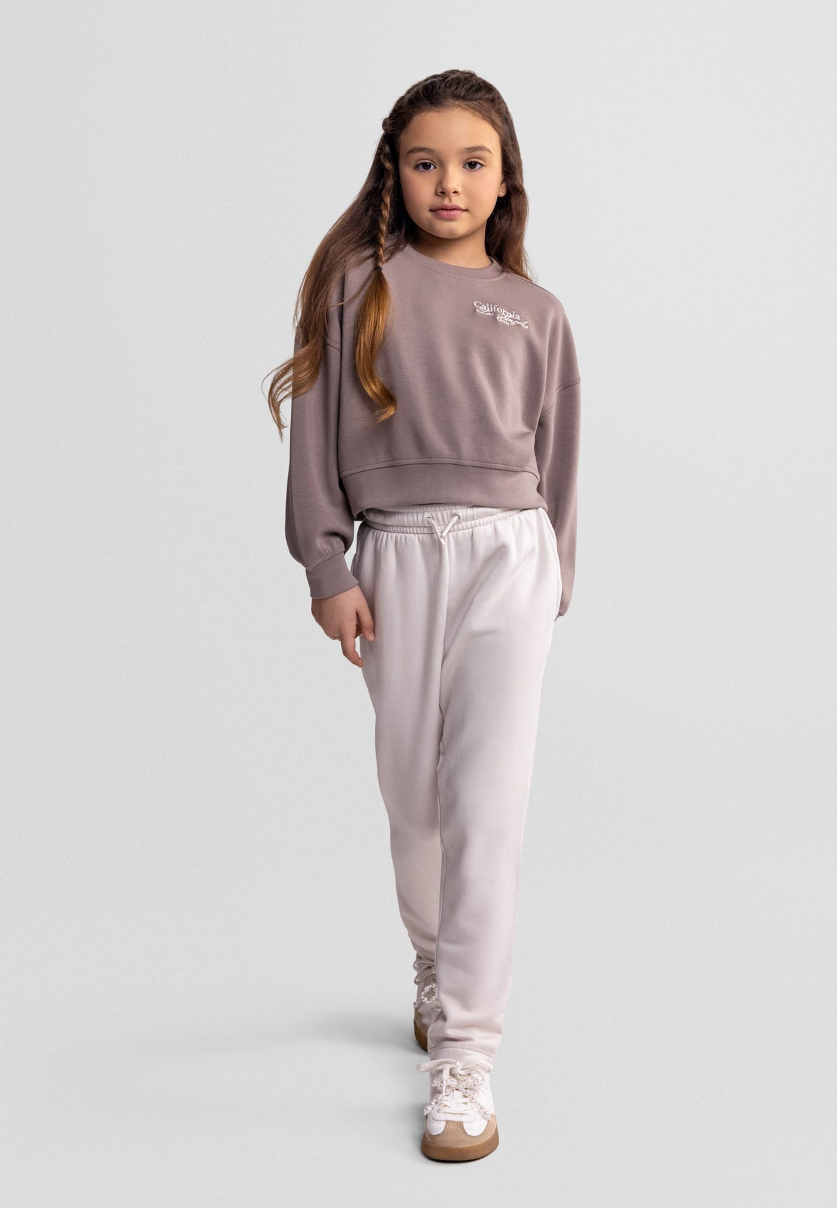 Cream straight-leg drawstring trousers, model front.