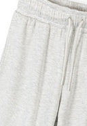 Close-up of soft mottled light grey wide leg joggers with elasticated waistband and drawstring for adjustable fit design