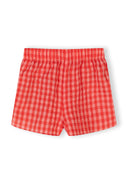 Red and pink gingham shorts for girls with elastic waistband and unique design details for kids fashion.