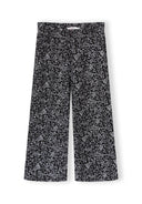 Wide leg trousers for girls with a black base and delicate white floral print, designed for comfort and style.
