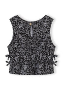 Back view of black sleeveless floral print pullover with side ties and button closure for kids