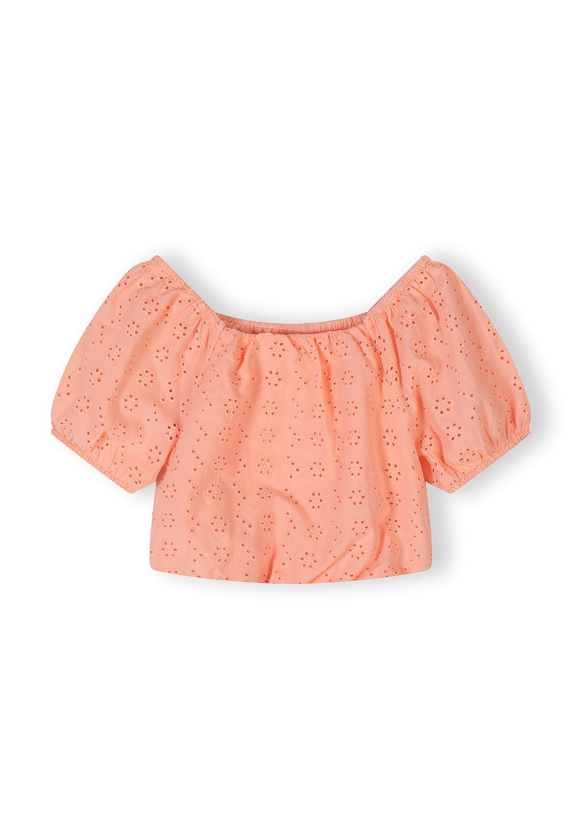 Close-up detail of apricot cotton fabric showing delicate broderie anglaise eyelet embroidery pattern with floral motifs and elasticated waistband