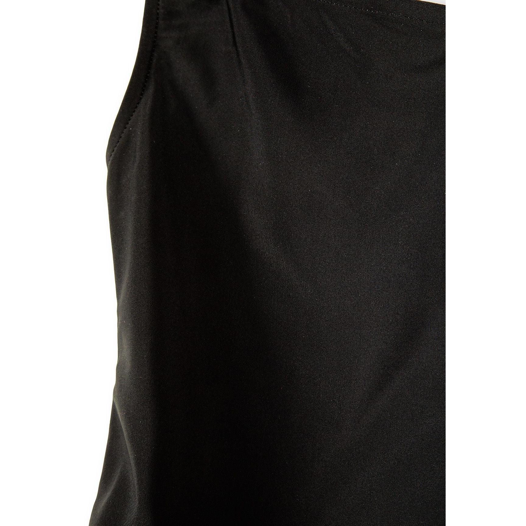 Close-up detail of black swimsuit fabric texture and construction showing smooth material finish