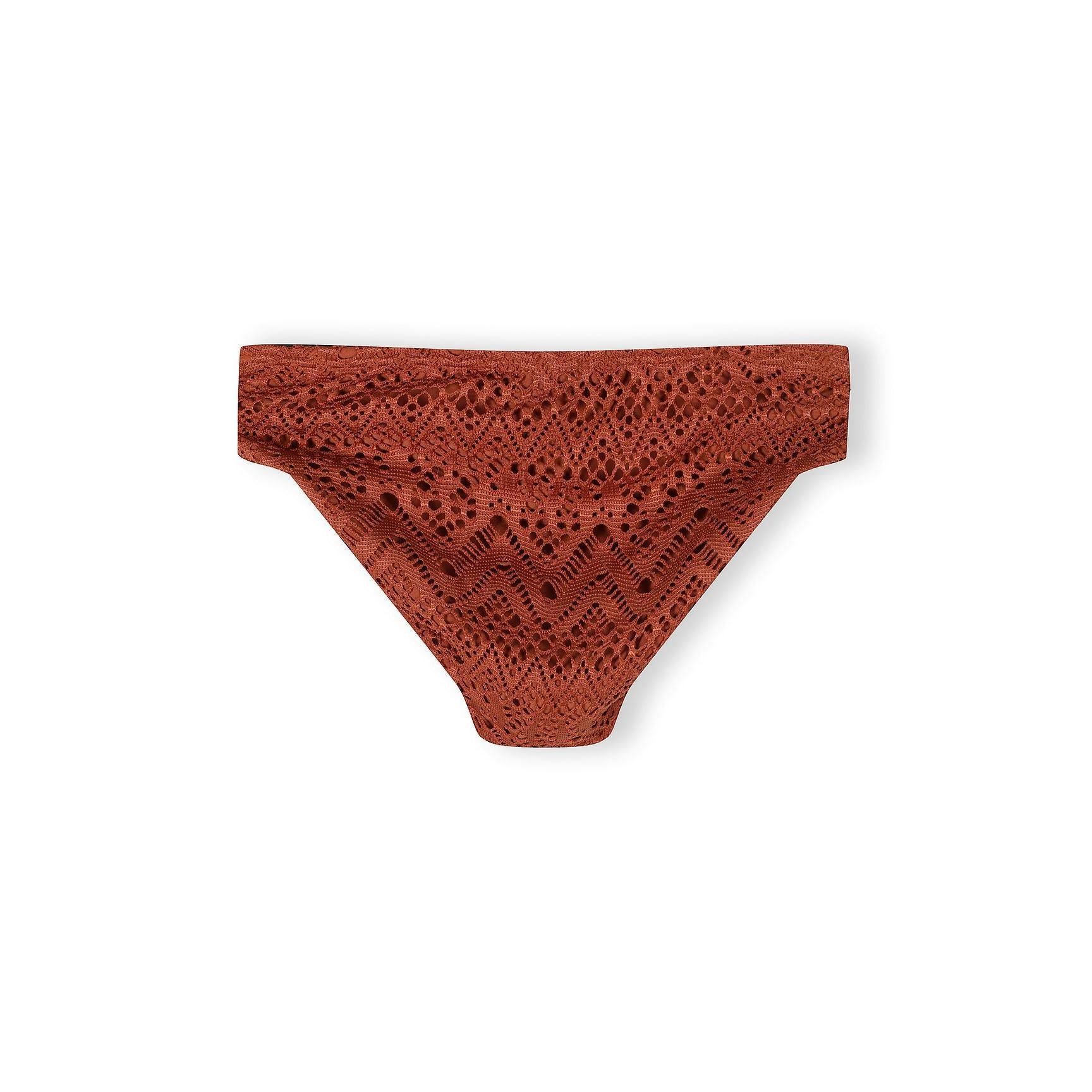 Close-up detail of copper crochet bikini showing intricate diamond and geometric lace pattern with gold charm detail on adjustable strap
