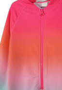 Close-up of girls long sleeve swimsuit with blue to pink ombre design and front zipper closure