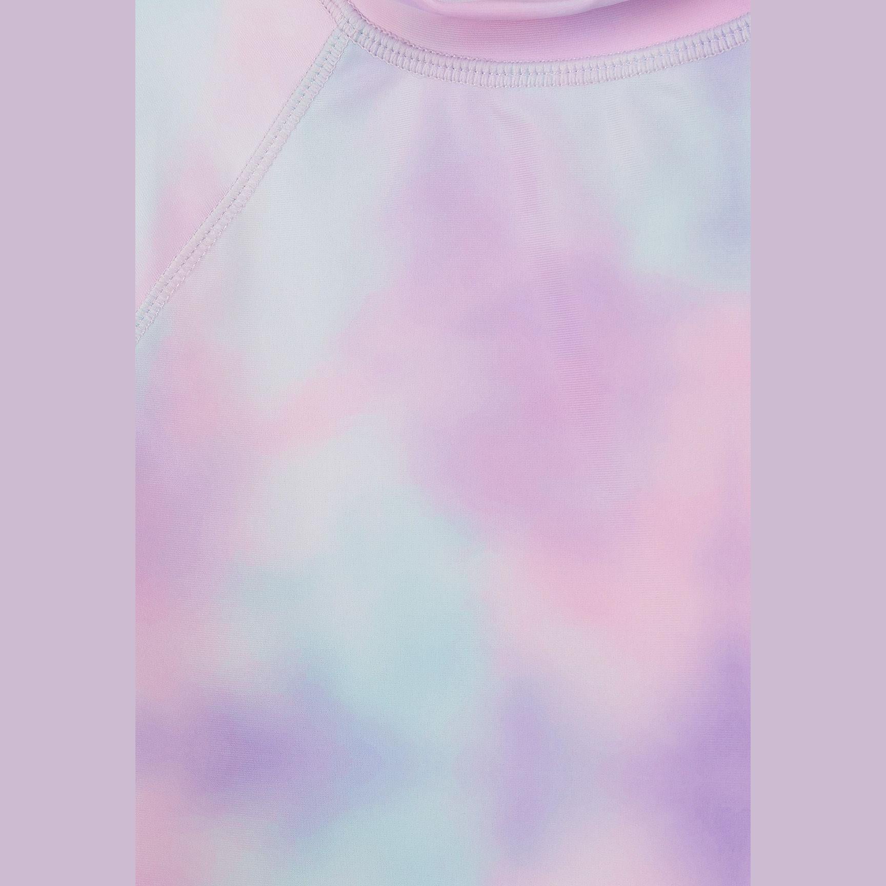 Close-up detail of pastel tie-dye fabric texture showing pink, purple and mint color blend in swim t-shirt material