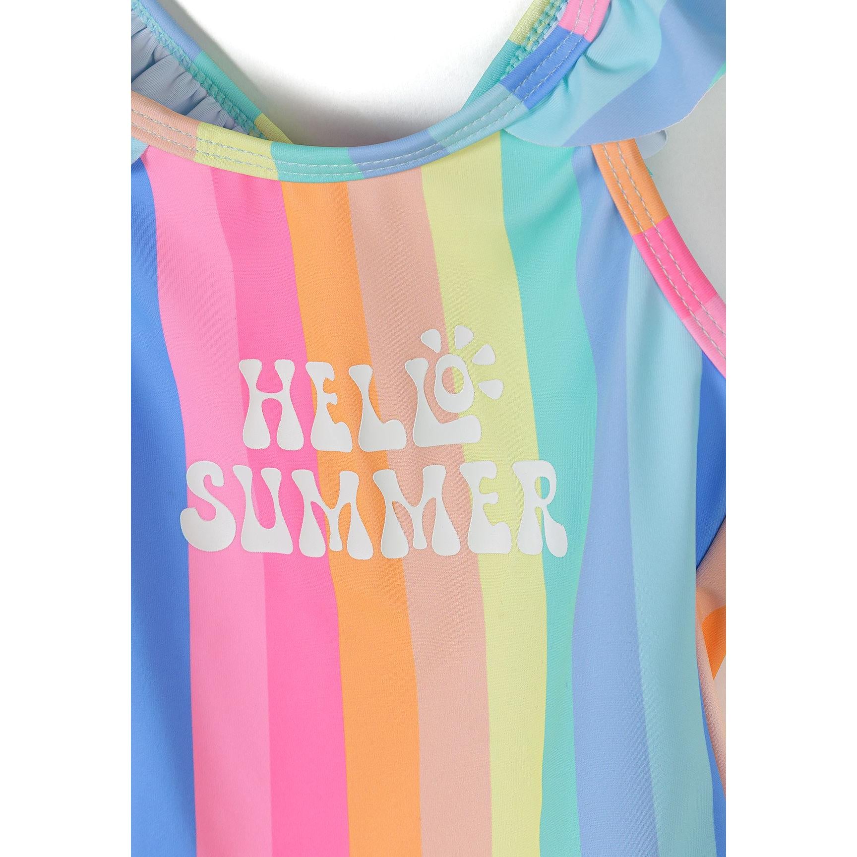 Close-up detail of HELLO SUMMER white text print over rainbow striped fabric with ruffle neckline trim