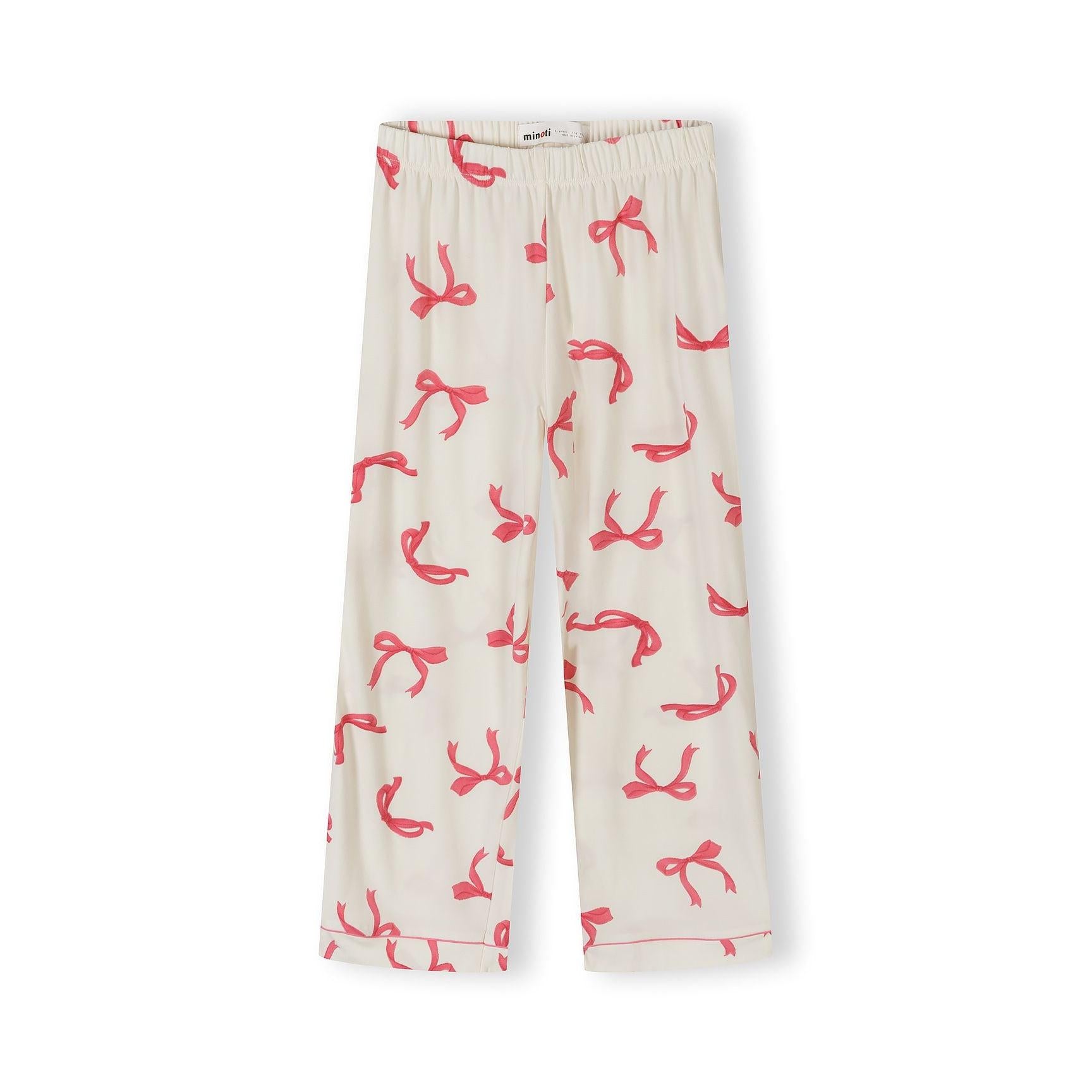 Detail shot of pyjama top showing Minoti brand label, button closure, chest pocket and pink bow print on cream fabric