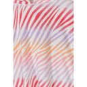 Close-up detail of multicoloured zebra stripe pattern on white towelling fabric showing pink purple orange gradient stripes