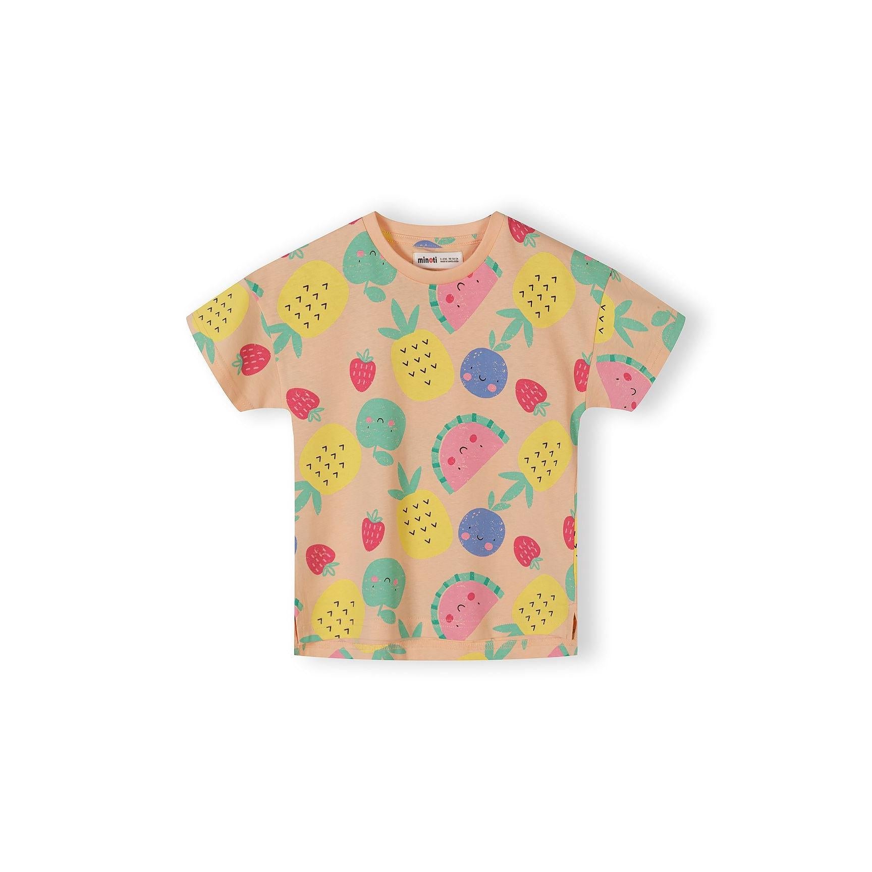 Single apricot-coloured t-shirt with all-over fruit print pattern showing pineapples, watermelons, strawberries and other fruits in bright colours on white background