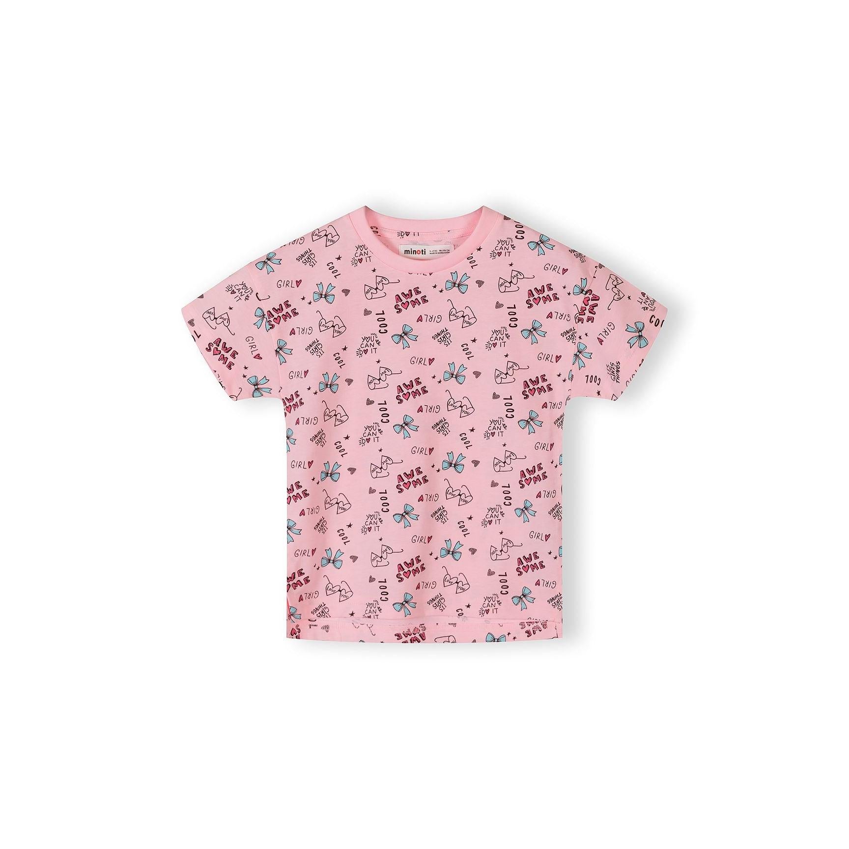 Single white cotton t-shirt with all-over bow print pattern featuring blue bows, pink text reading 'AWESOME' and 'GIRLY' scattered across fabric on white background