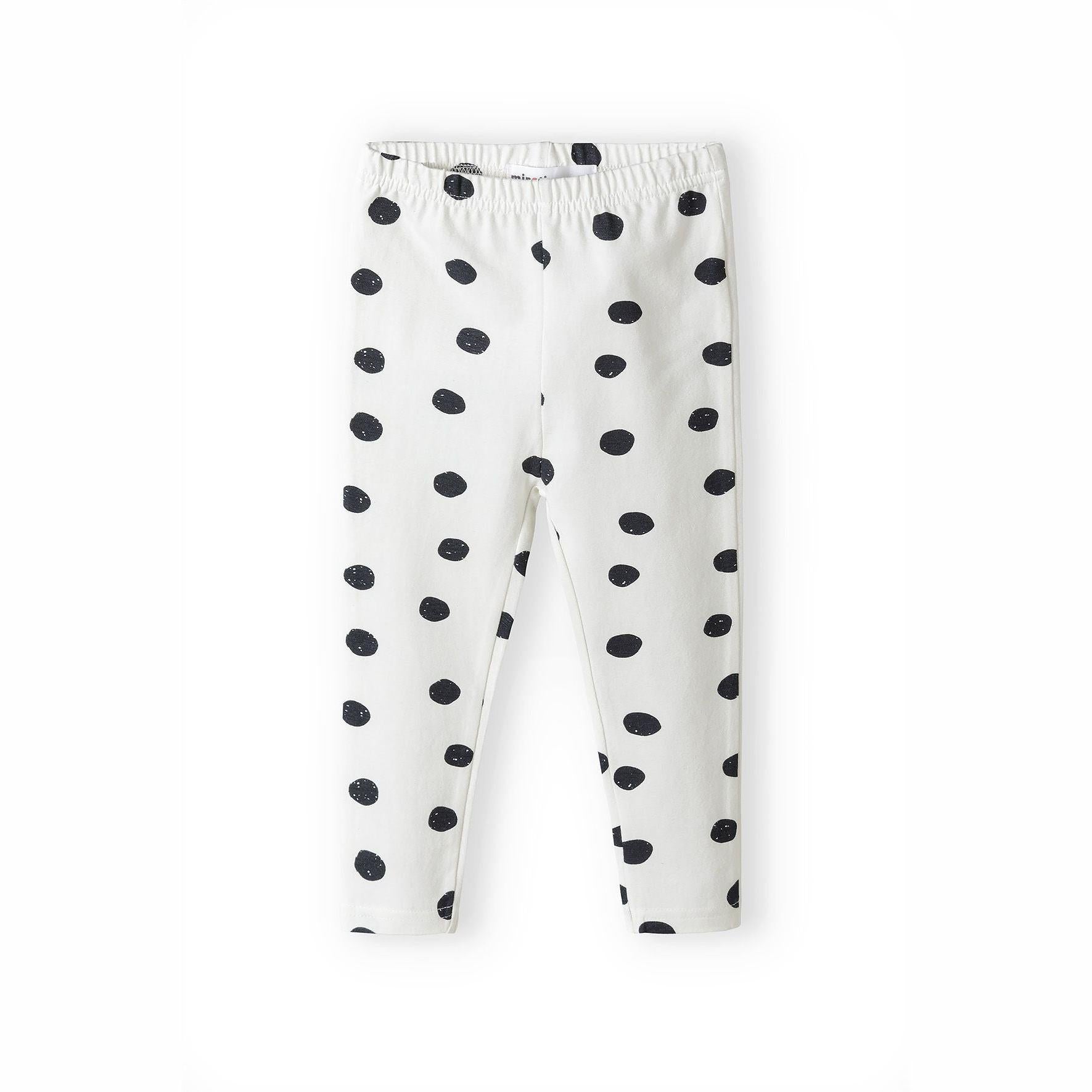 White leggings with black polka dot pattern laid flat showing elasticated waistband, on white background