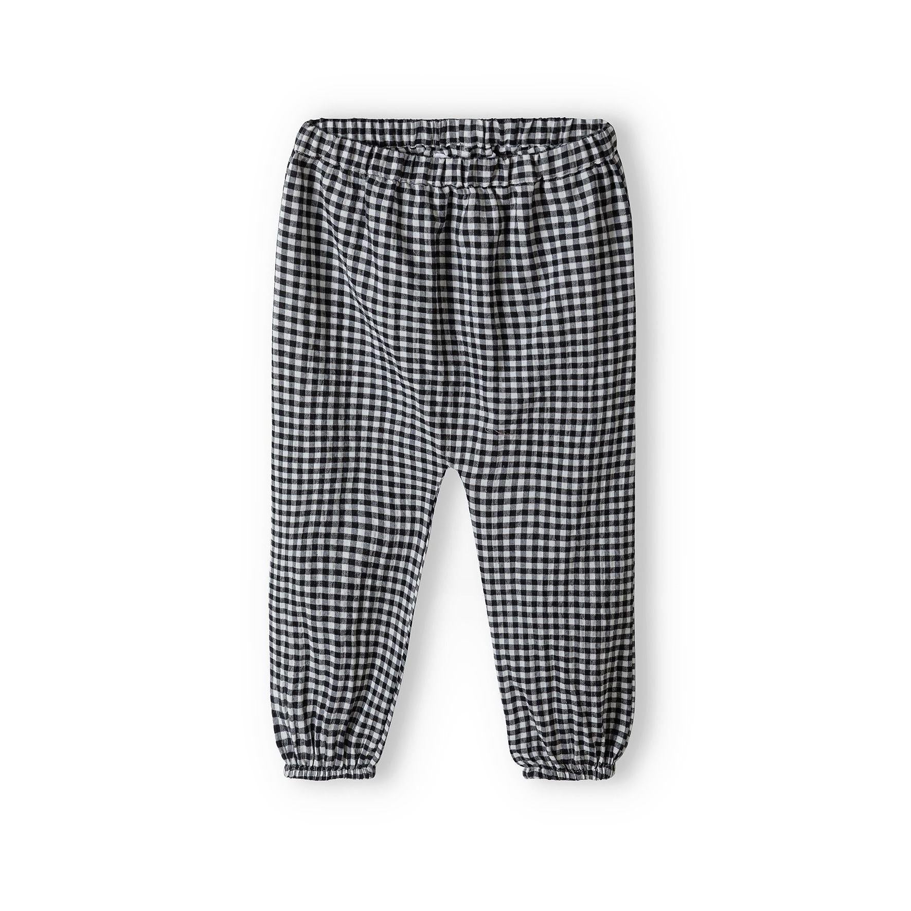 Black and white gingham check harem trousers with elasticated waistband and cuffs photographed flat on white background