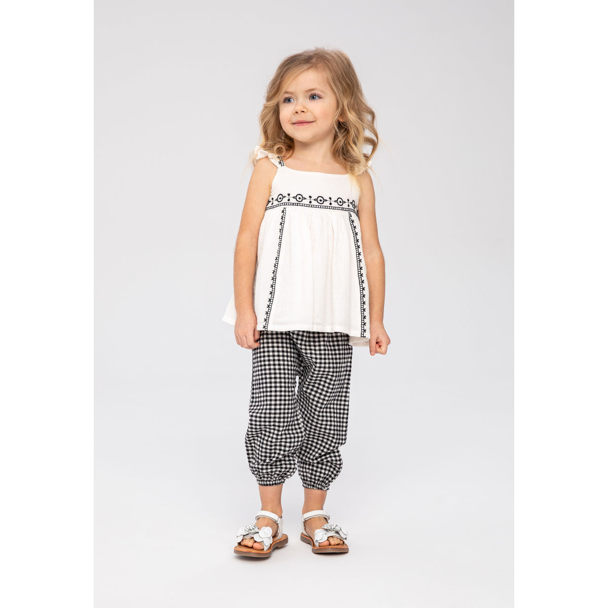 Girls' embroidered top and trousers set in white and black — complete product view for square Shop card