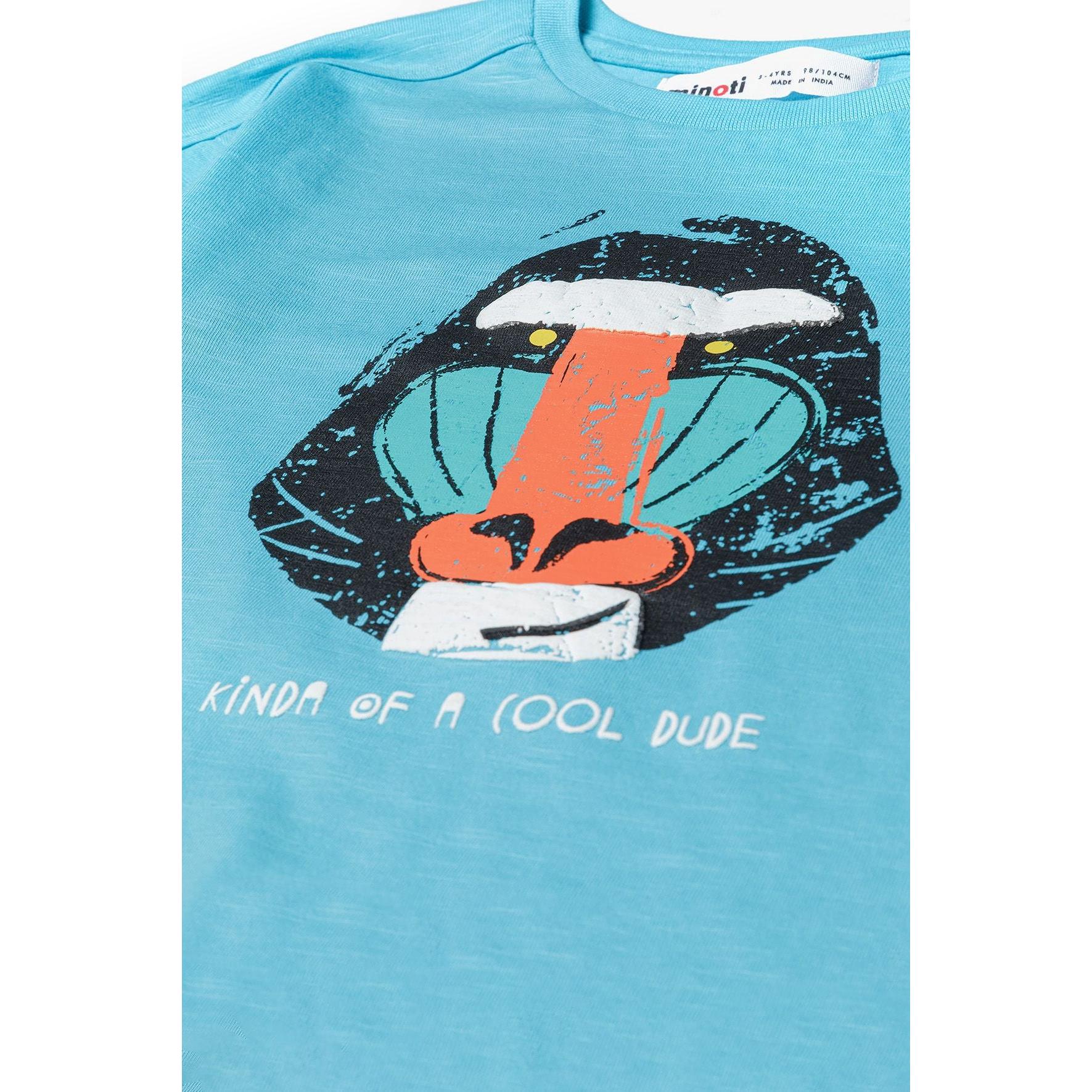 Close-up detail of turquoise t-shirt showing distressed puff print sloth graphic with 'kinda of a cool dude' text and Minoti label