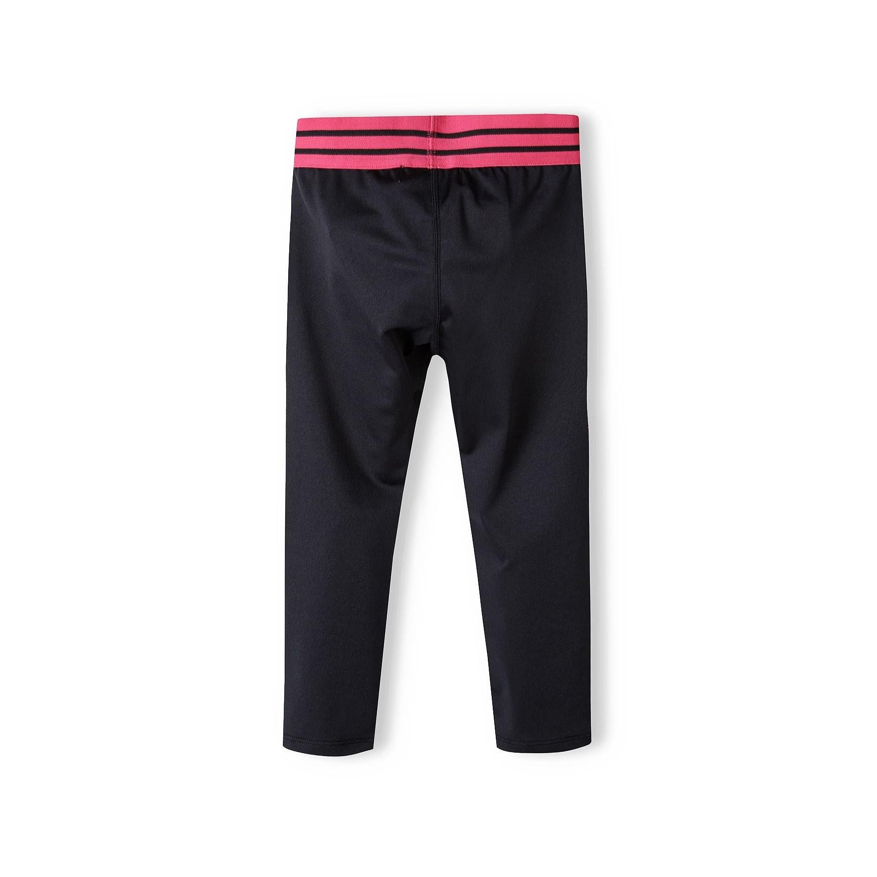 Flat lay view of black sport leggings showing pink and black striped elasticated waistband detail against white background