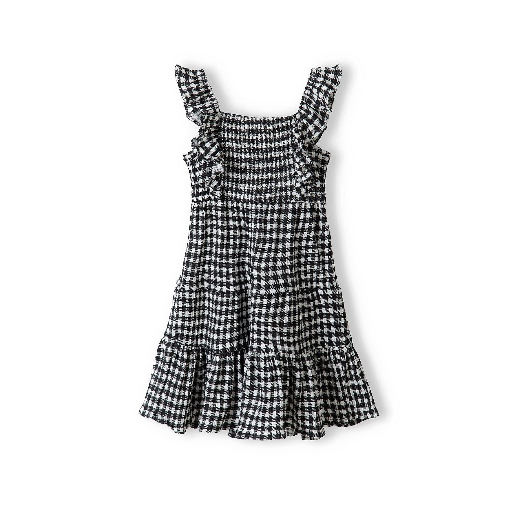 Black and white gingham tiered dress laid flat showing shirred bodice, flutter sleeves and three-tier skirt construction