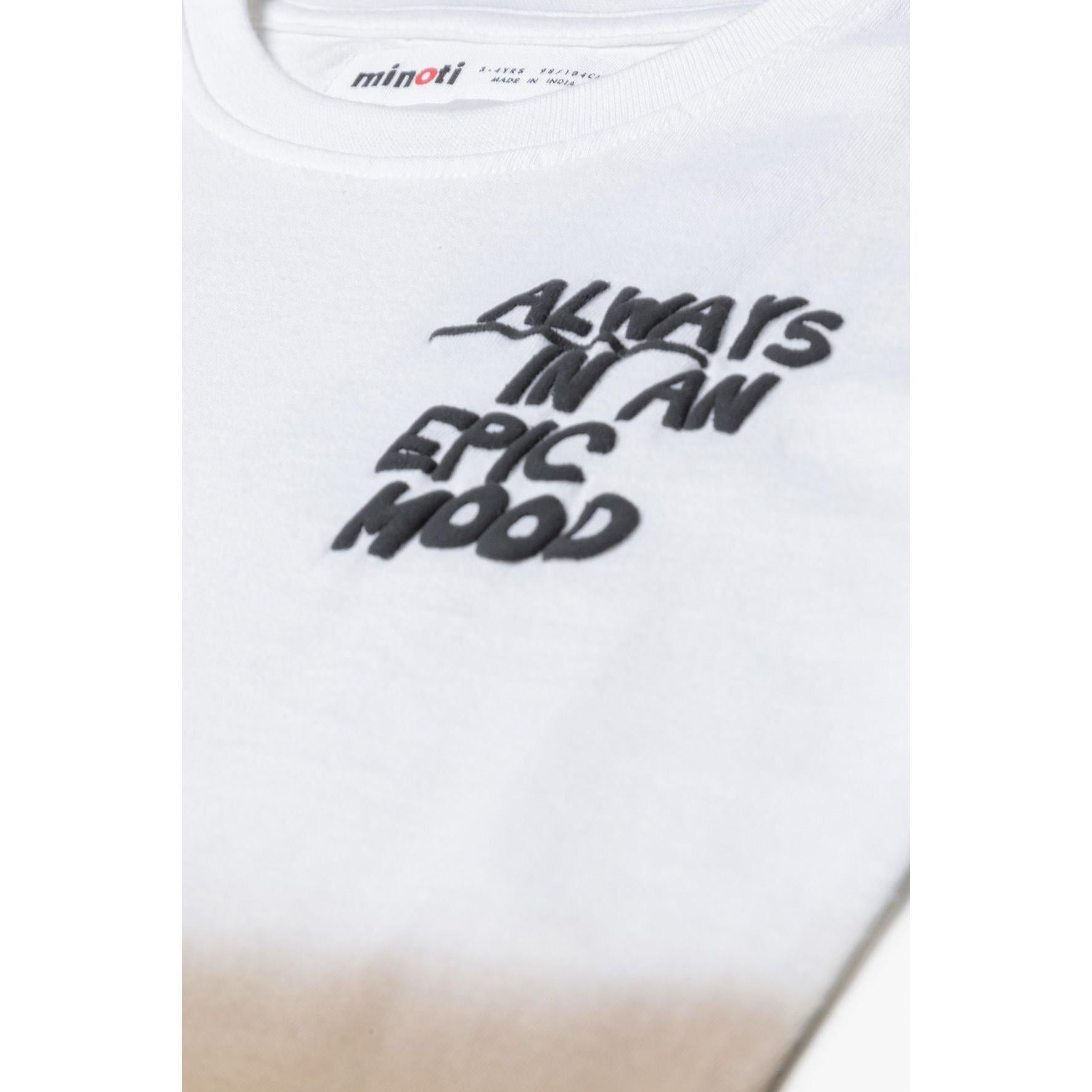 Close-up detail of white t-shirt showing Minoti brand label at neckline and black textured puff print text 'Always In An Epic Mood'