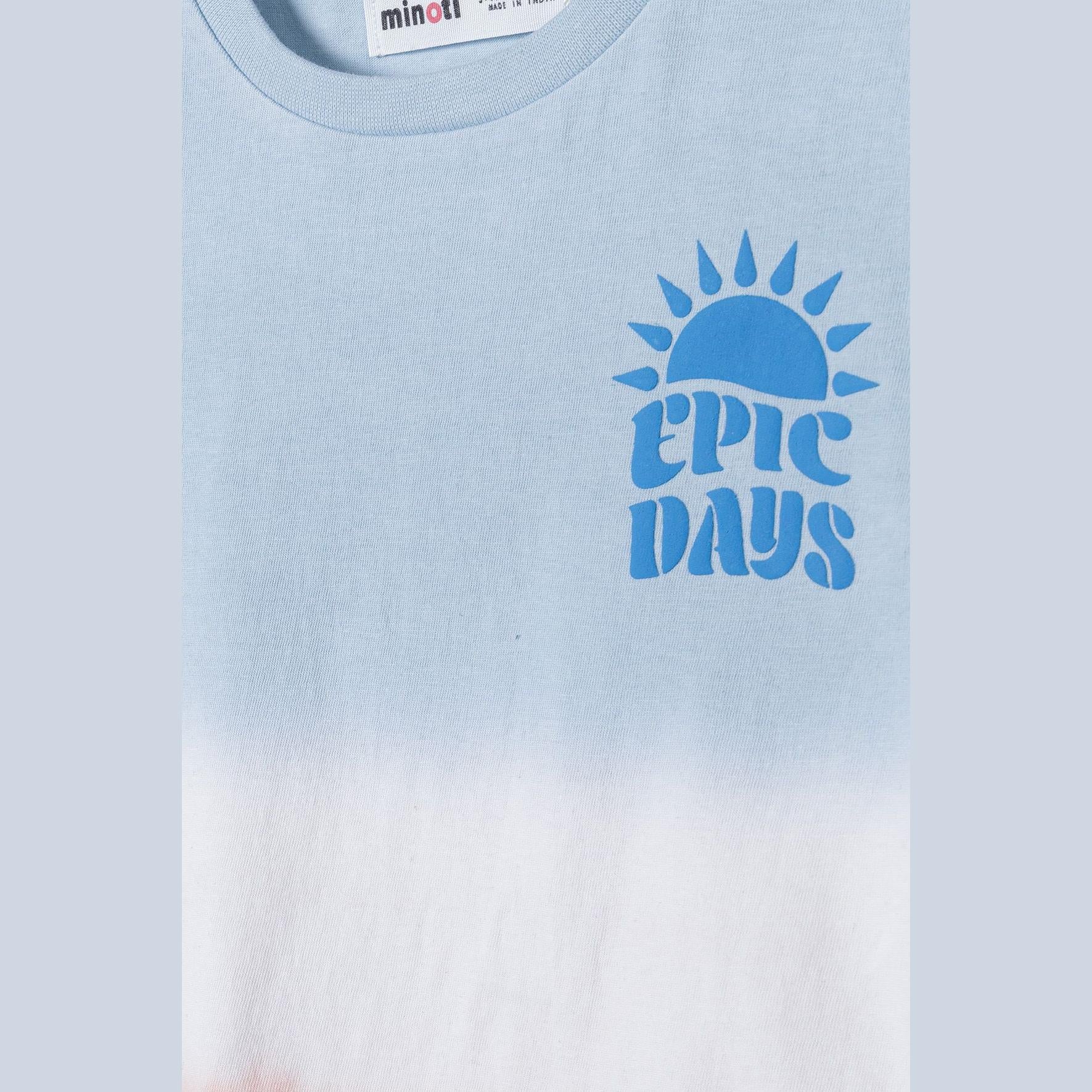 Close-up detail of Epic Days blue puff print with sun design on light blue dip dye t-shirt fabric showing Minoti label