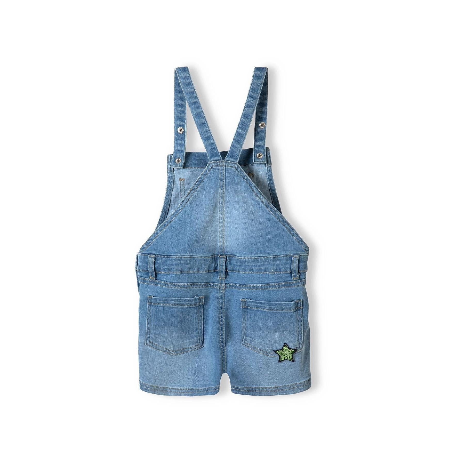 Back view of light blue denim short dungarees showing adjustable shoulder straps, back pockets and sequin star patch detail