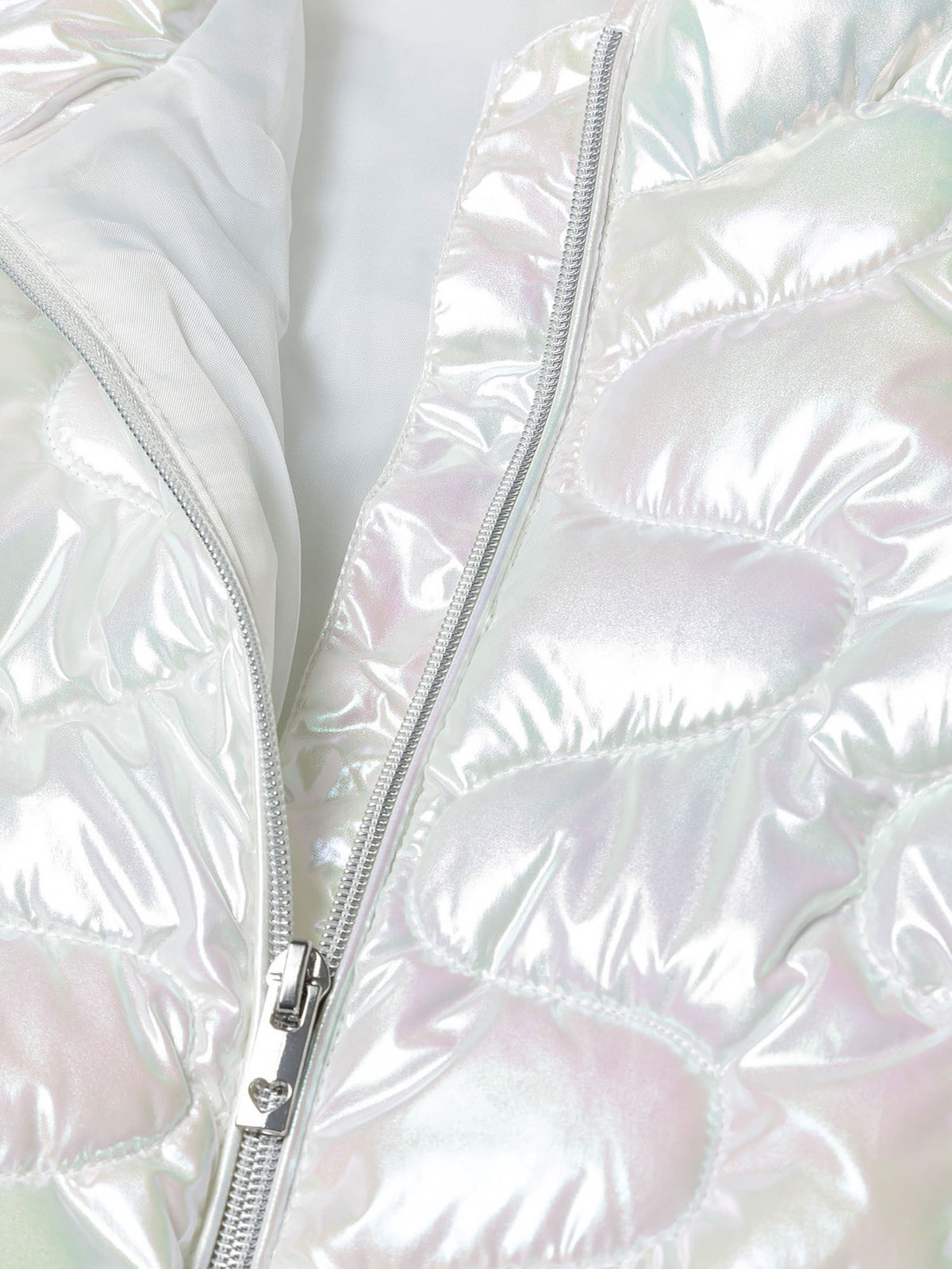 Close-up of the zip and lining on the white quilted jacket.