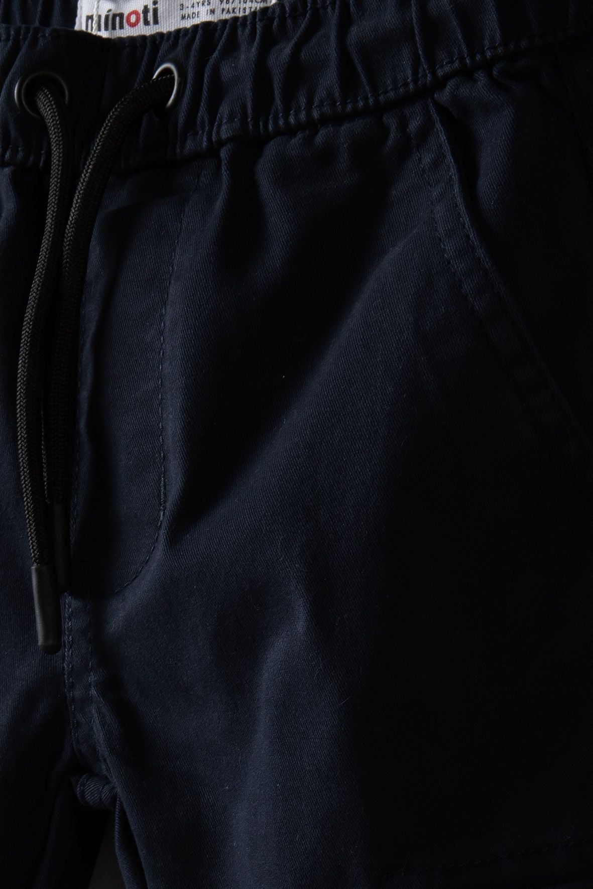 Navy cargo trousers, drawstring waist and side pocket.